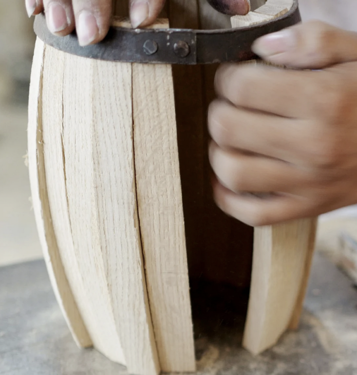 bespoke post cask making with hands making the cask