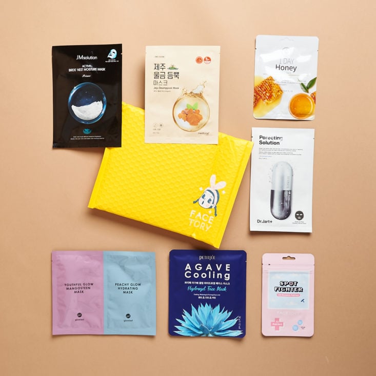 group shot showing the sheet masks arranged around the bubble mailer