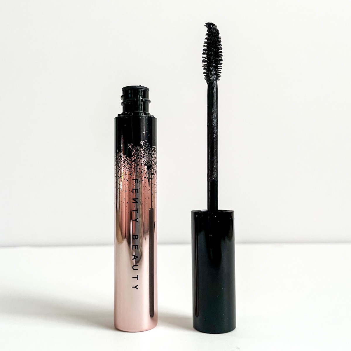 opened mascara tube showing wand with uneven bristles