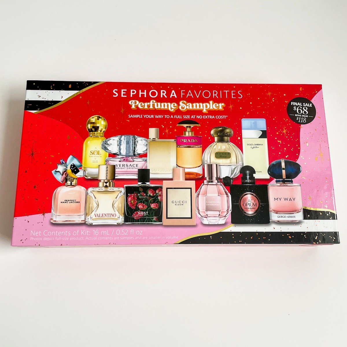 red and pink box with pictures of perfume bottles