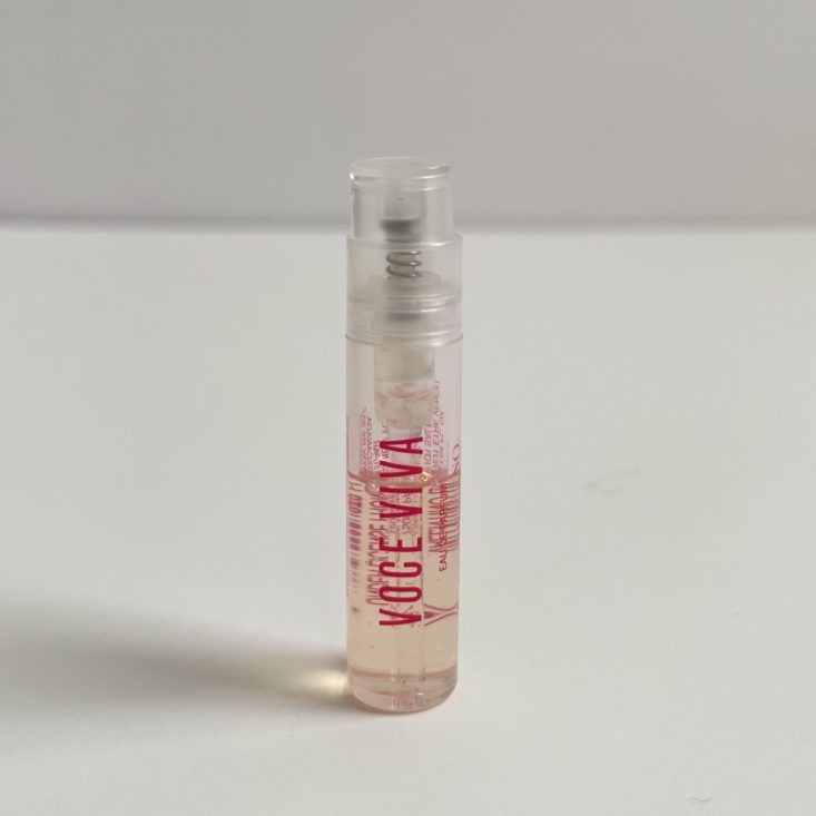 clear perfume bottle with clear top and pink lettering
