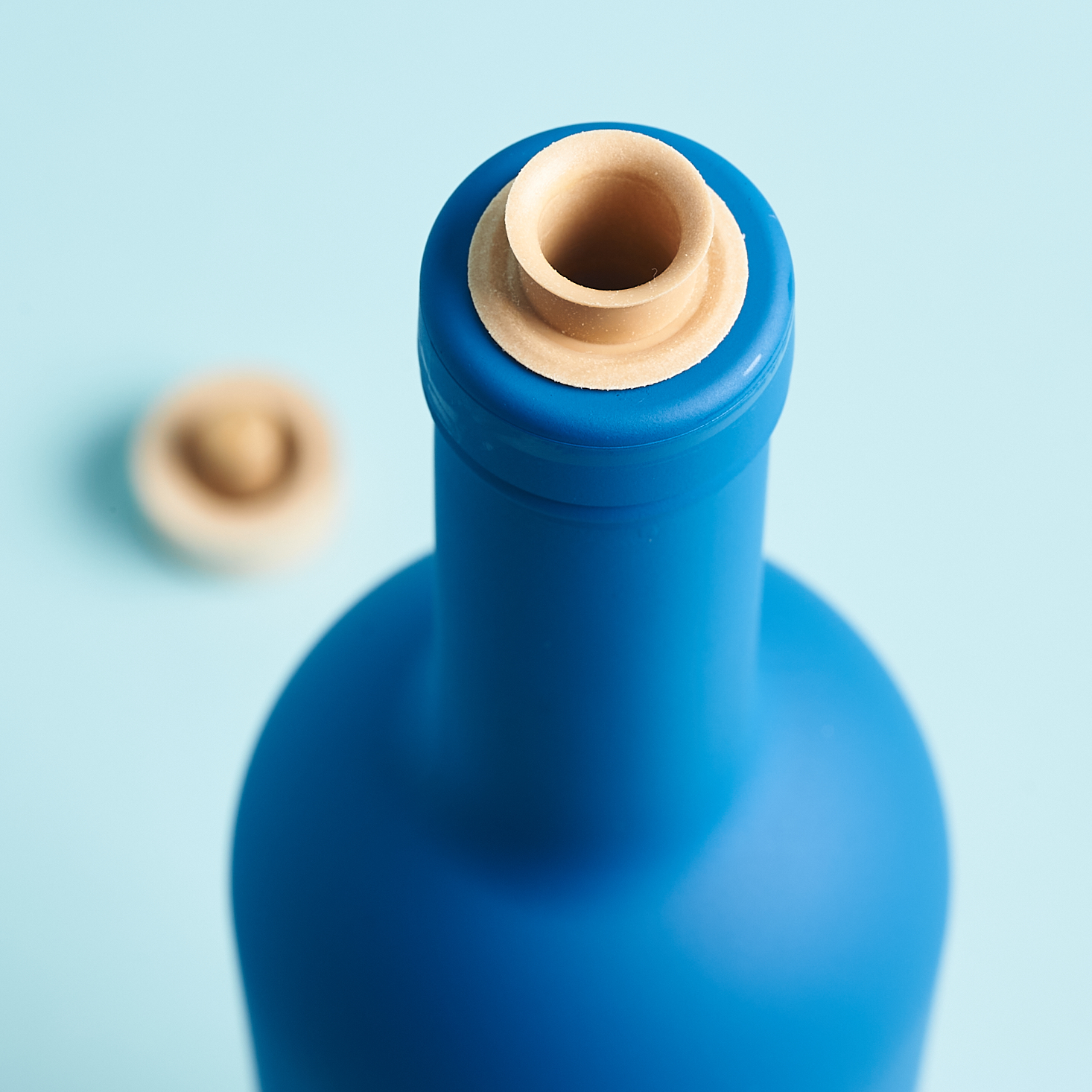 closeup of blue bottle showing spout top