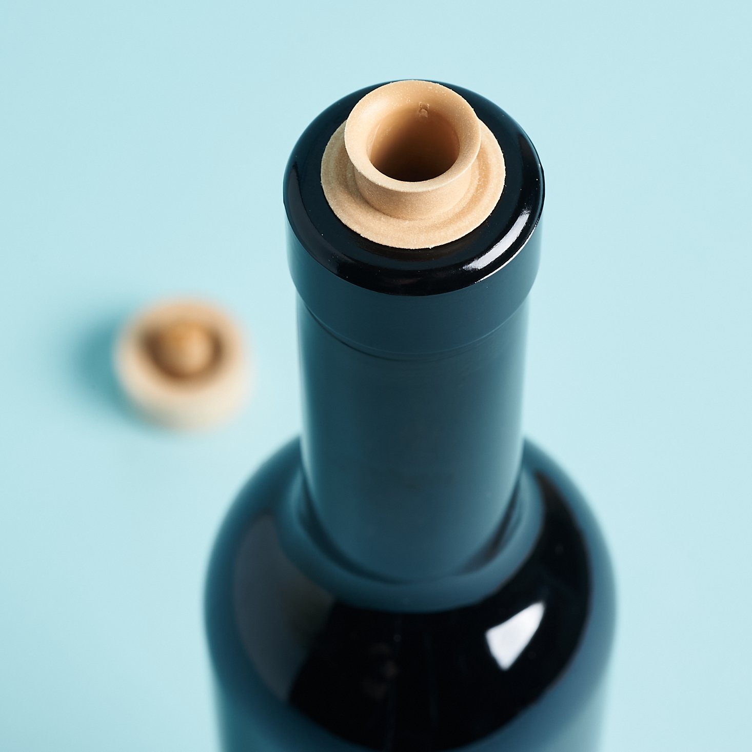 closeup of black bottle showing open pour spout top