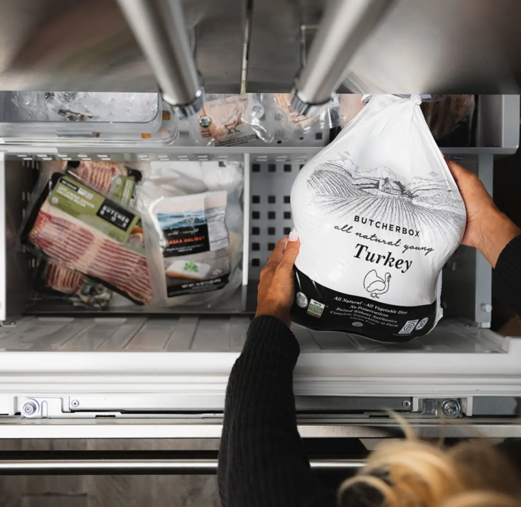 Butcher Box turkey being pulled out of a freezer