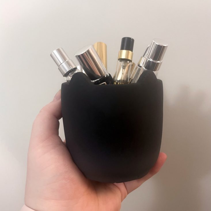 black planter holding perfumes