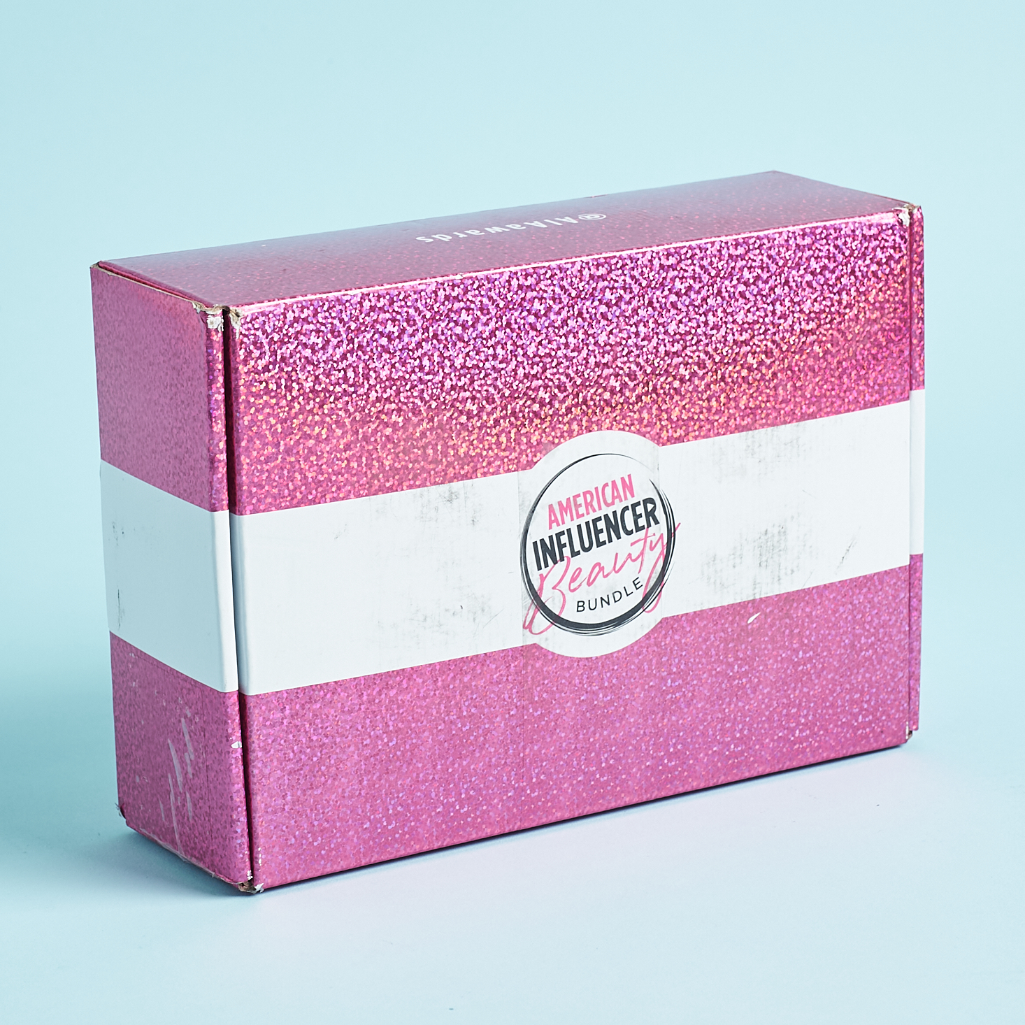 sparkly pink and white box on blue background