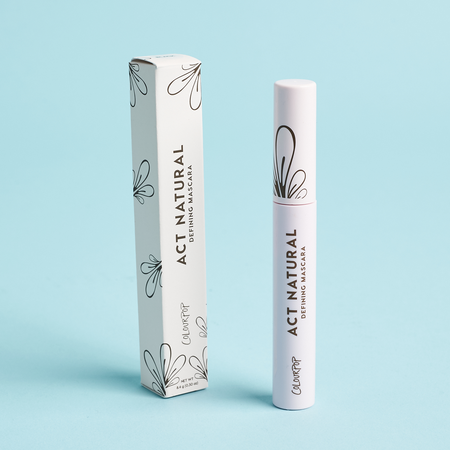 white closed tube of mascara next to white box