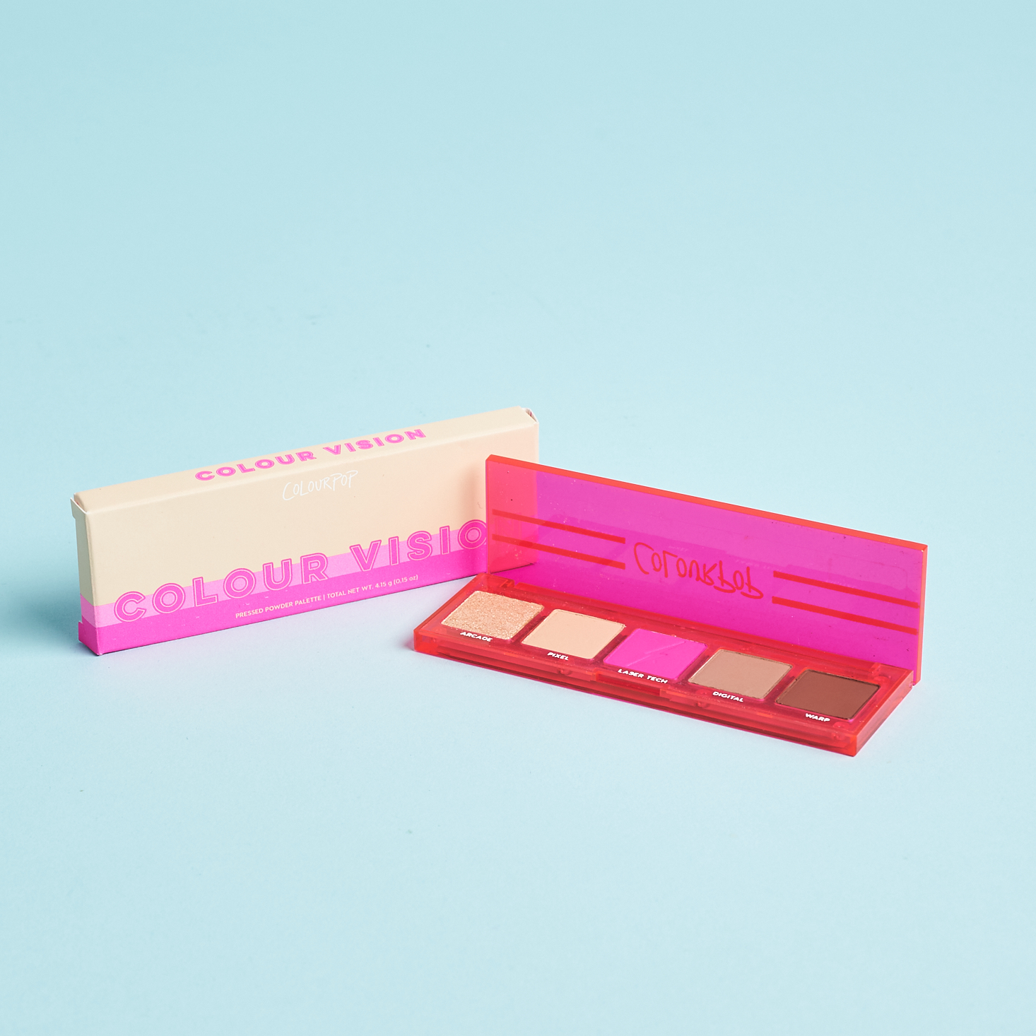 neon pink plastic eyeshadow palette next to box