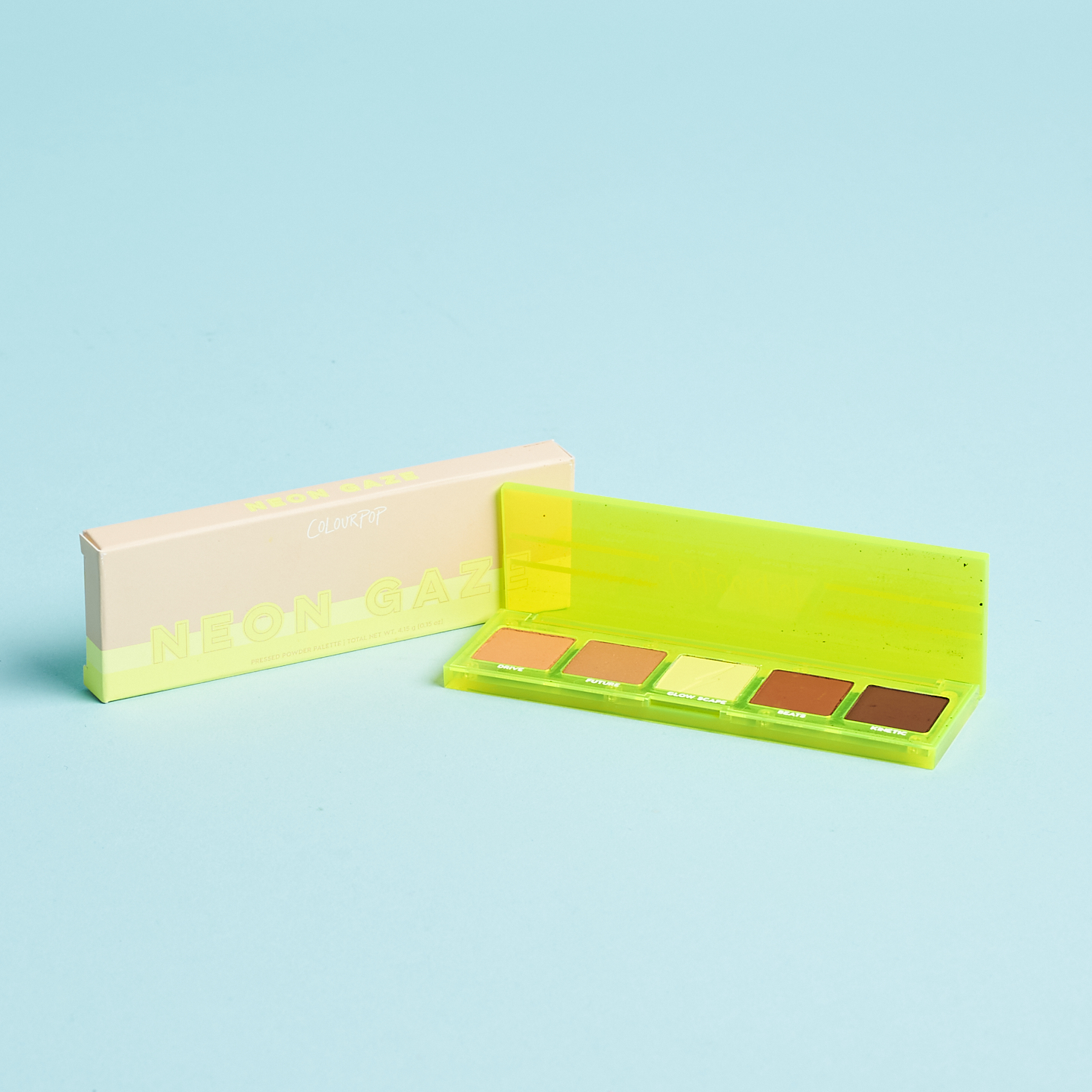 neon yellow plastic eyeshadow palette next to box