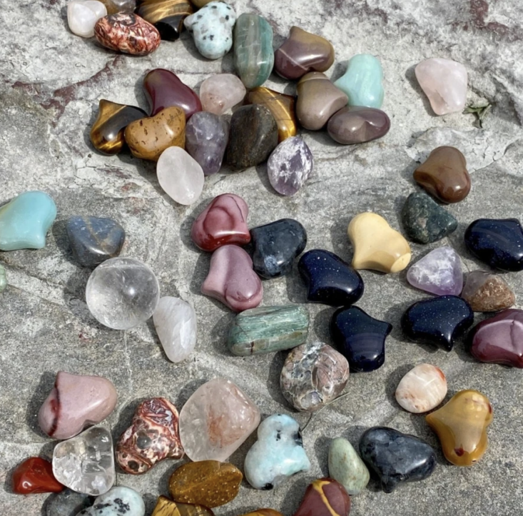 gemstones scattered on a stone surface