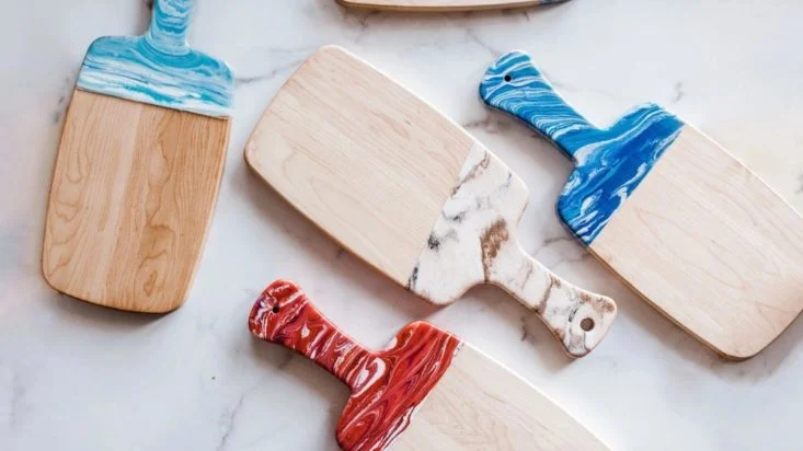 Photo of painted wood paddles from Adults & Crafts