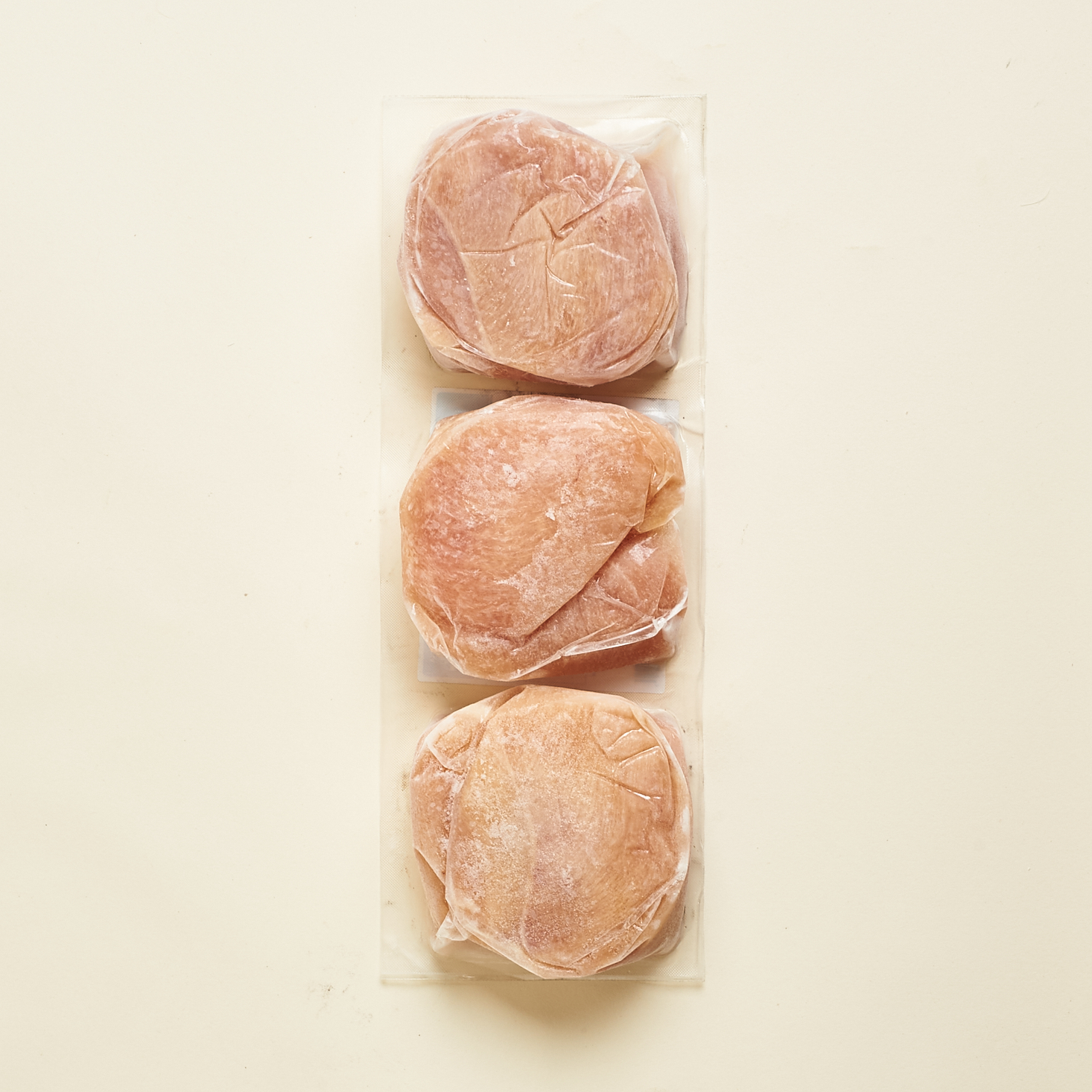 alternate view of three packs of frozen chicken