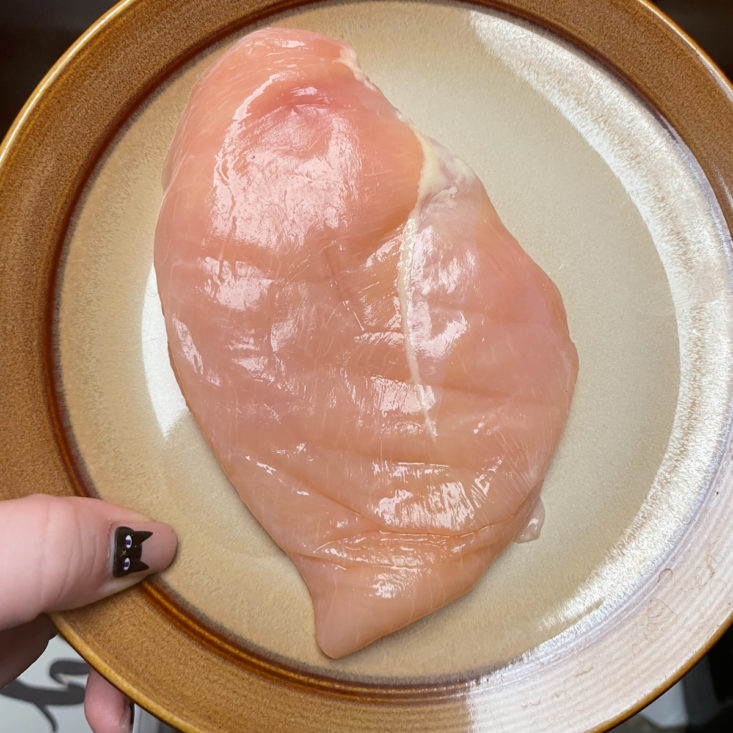 raw chicken breast on plate