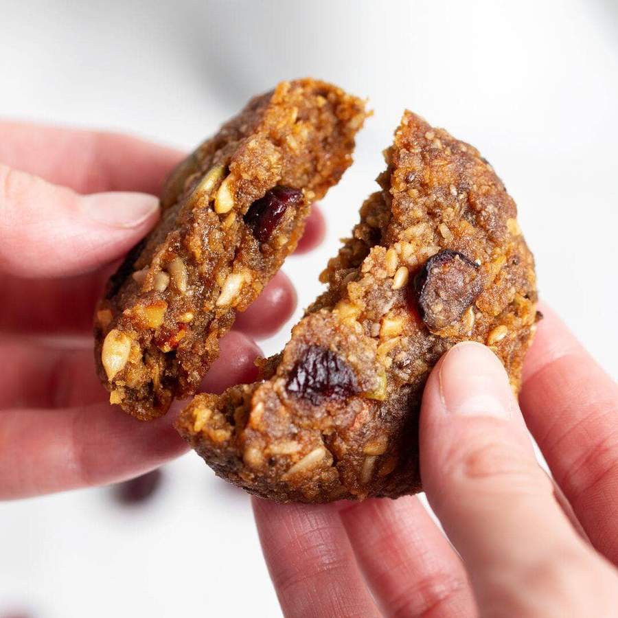 hands breaking a soft-baked cookie in half