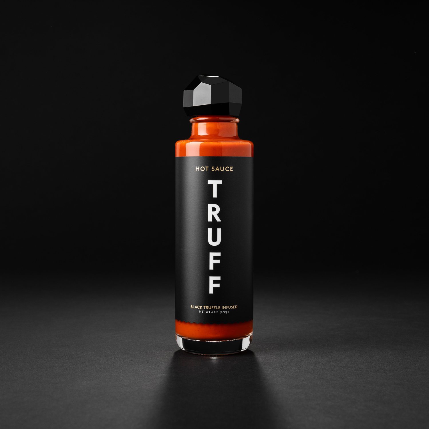 bottle of truff hot sauce on black bakground