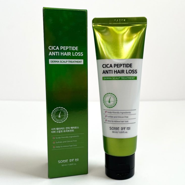metallic green tube with white label next to green box
