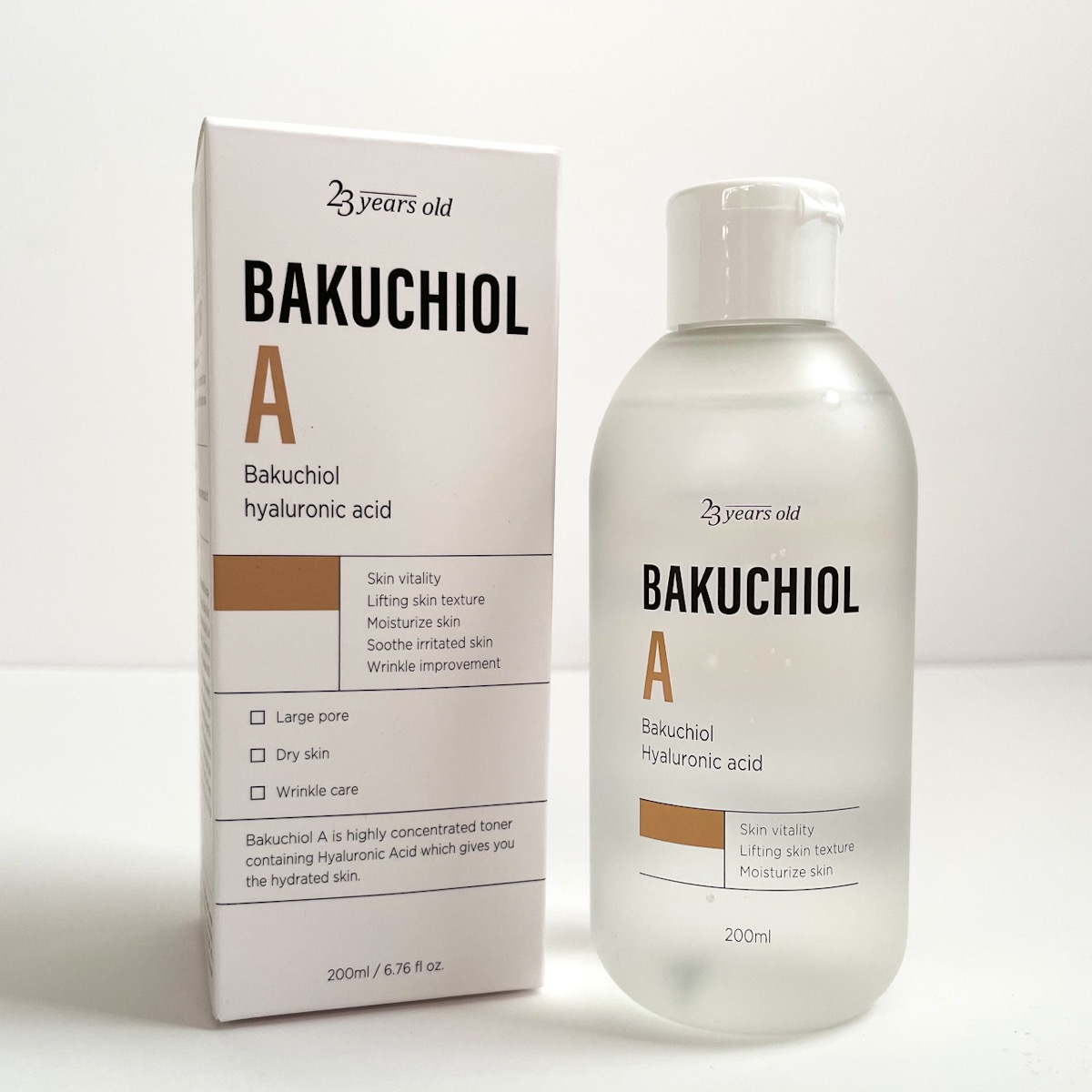 clear bottle of toner next to white box with brown and black lettering