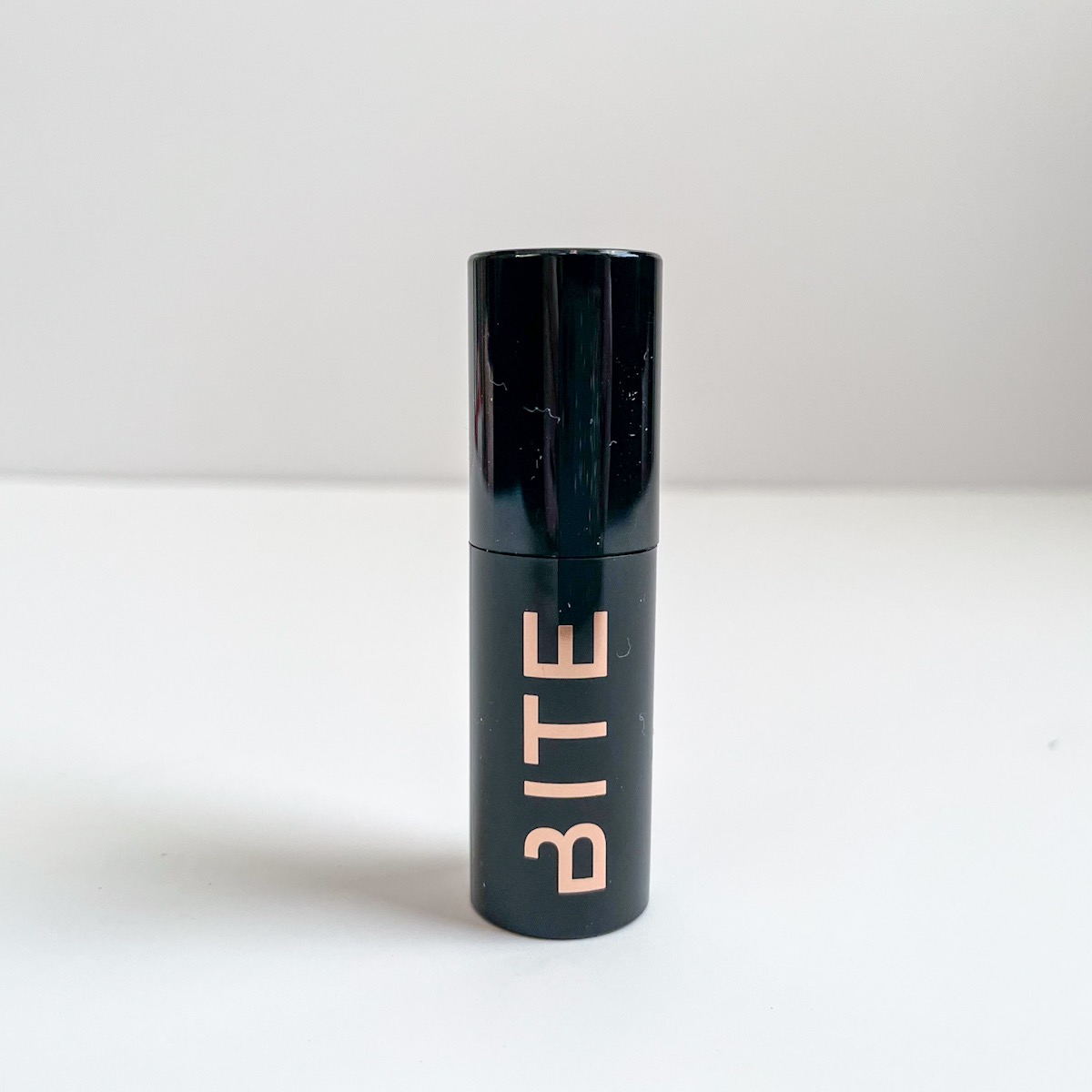 black mini mascara tube with rose gold lettering