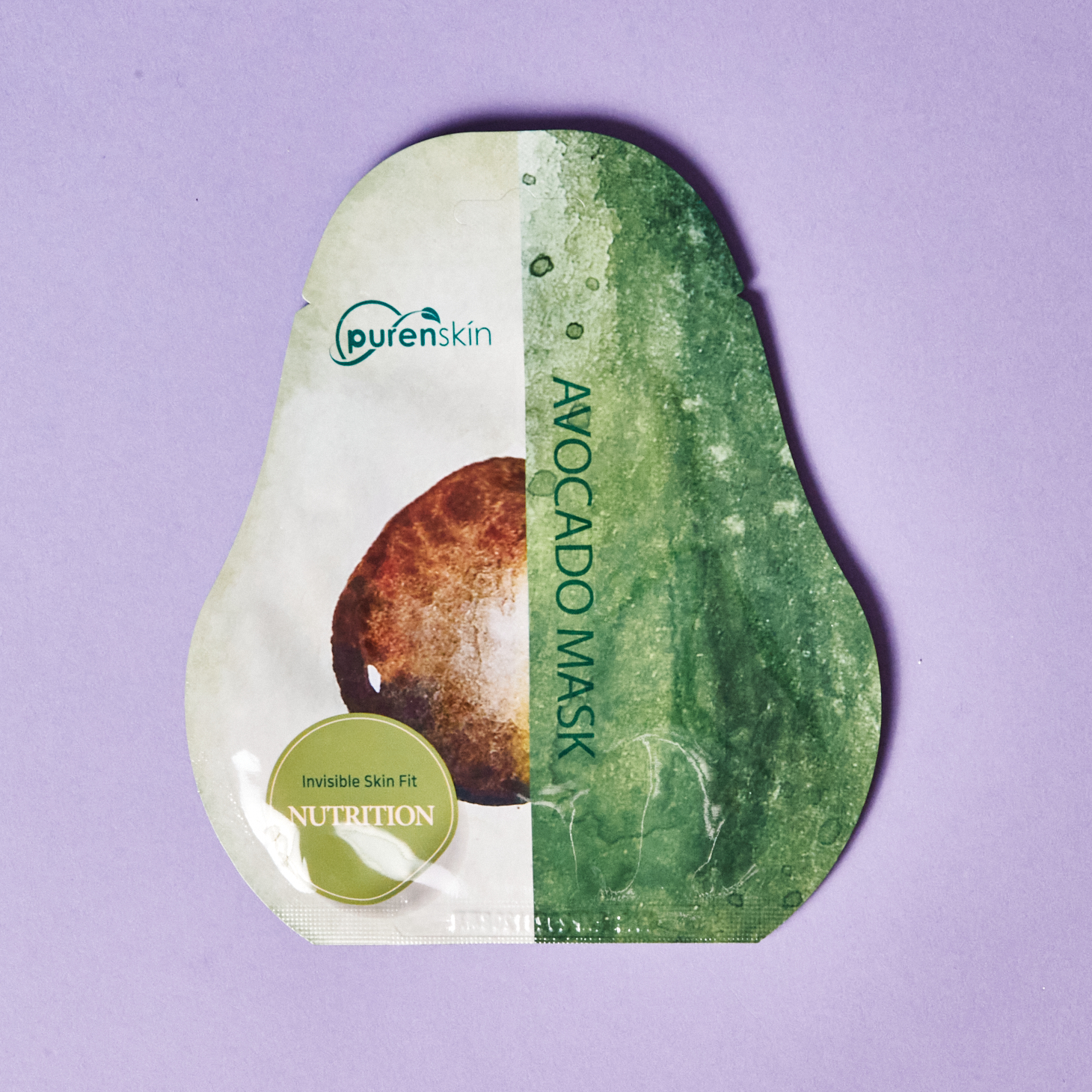 avocado shaped sheet mask with green and white front cover and brown avocado pit