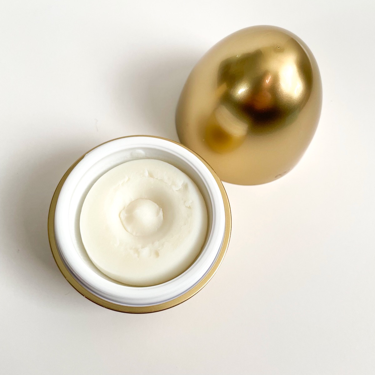 opened golden egg showing thick putty texture of primer