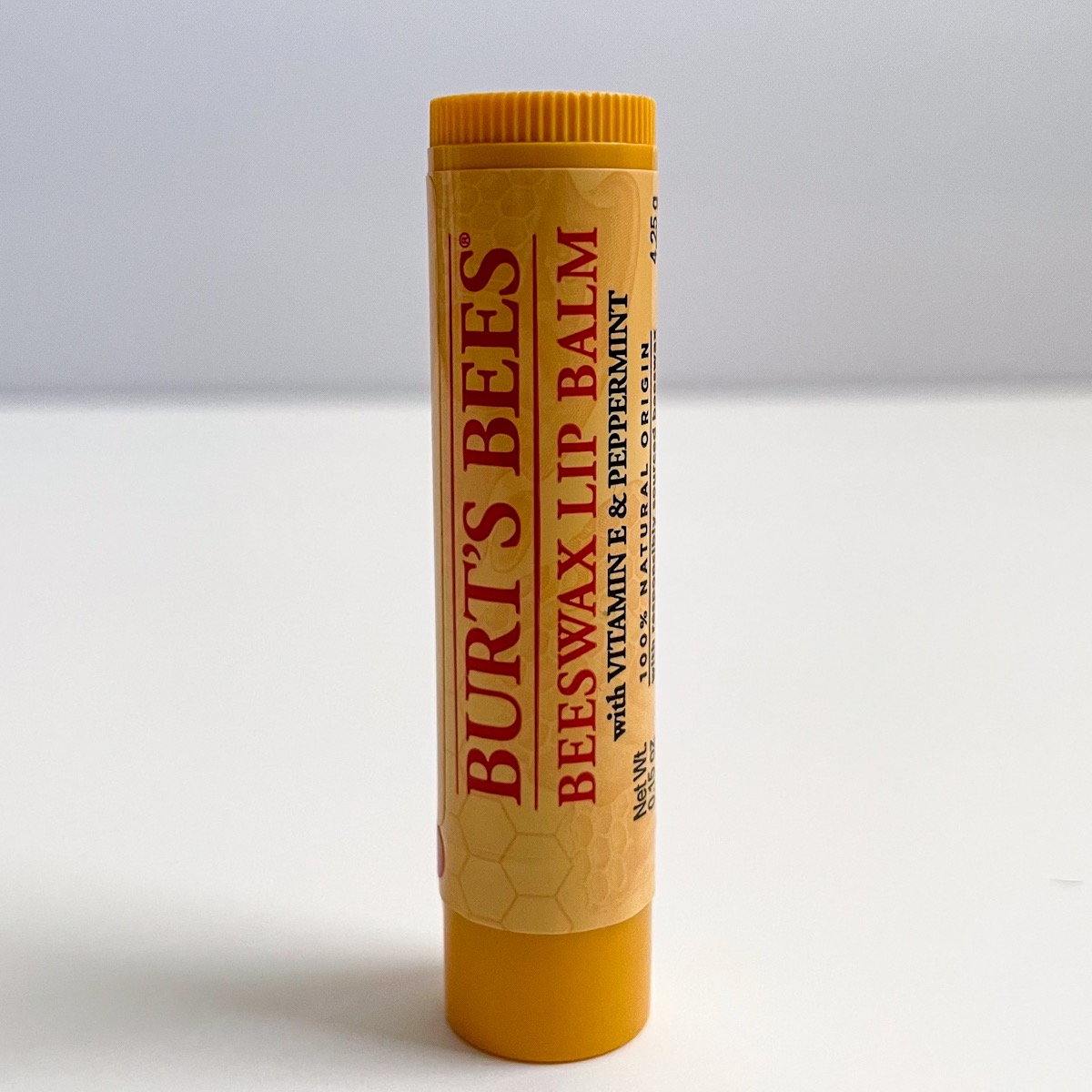 yellow and red tube of lip balm, closed