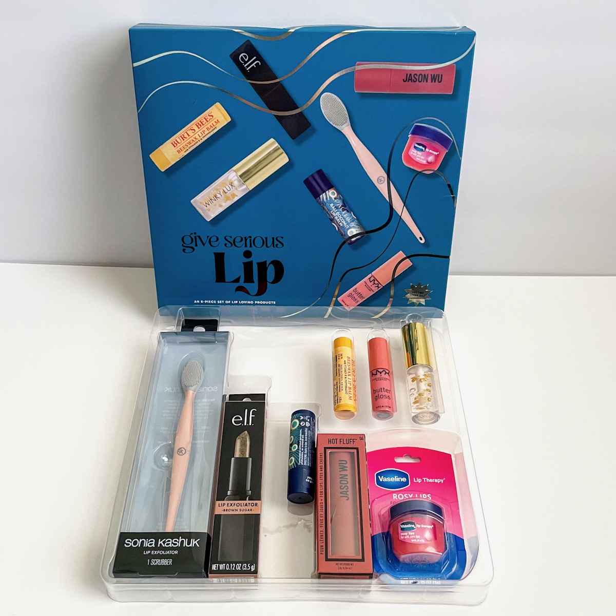 lip products in clear plastic liner next to blue box