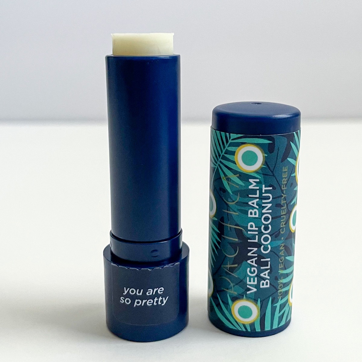 blue tube of lip balm, opened to show white lip balm texture