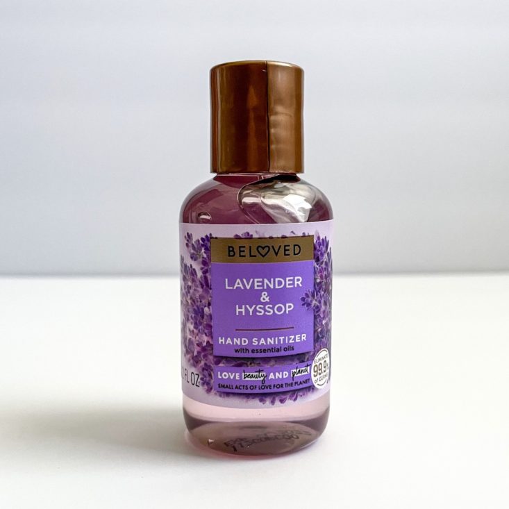 clear plastic bottle of lavender hand sanitizer with brown lid and purple and brown label