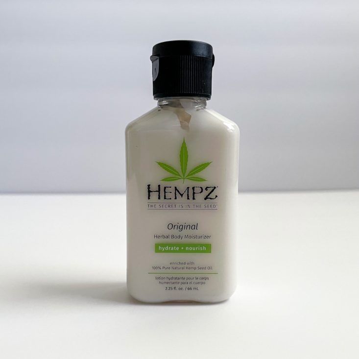off-white bottle of moisturizer with green hemp leaf