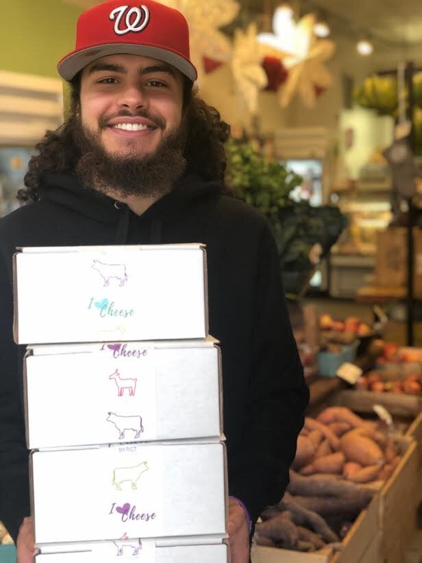 man holding boxes of the i love cheese subscription