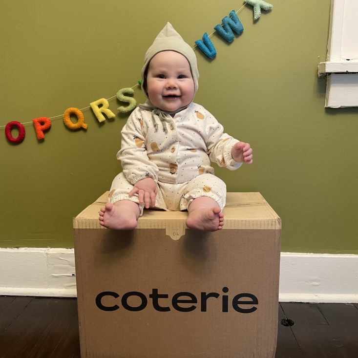 Baby sitting on top of a Coterie diaper box