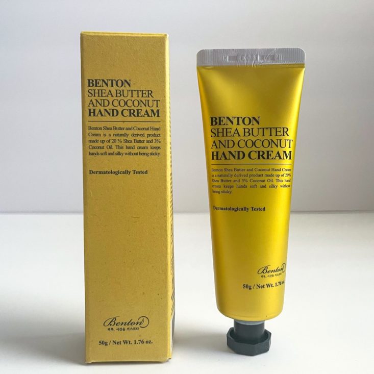 metallic yellow hand cream next to bold gold-yellow box