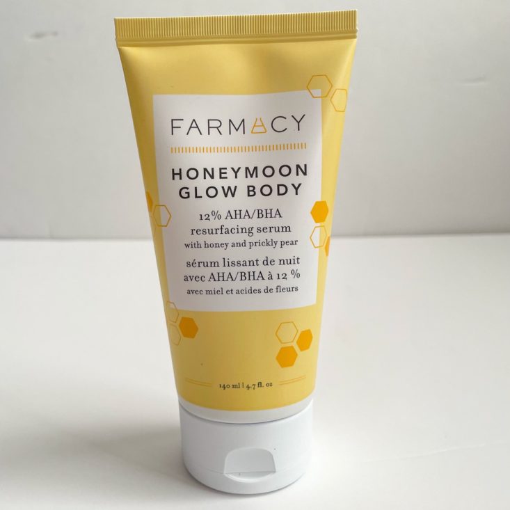 yellow tube of body lotion with scattered honeycombs 