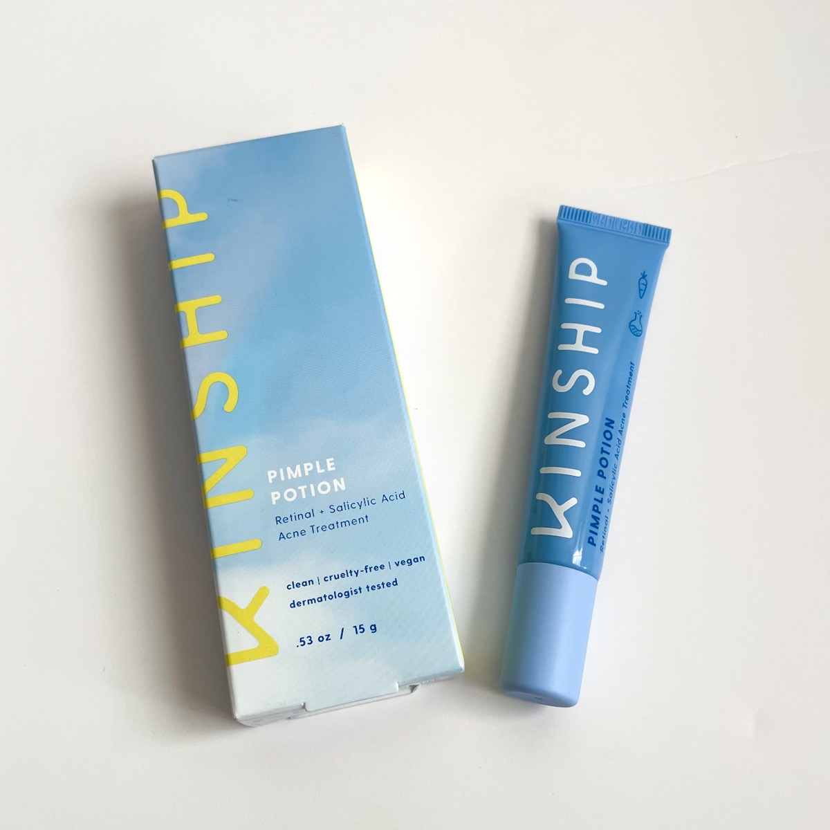 blue tube of acne treatment next to blue and yellow box