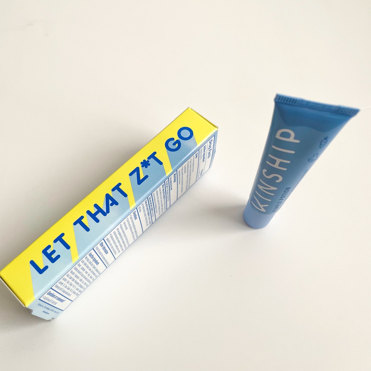 side view of blue and yellow packaging with blue tube at angle