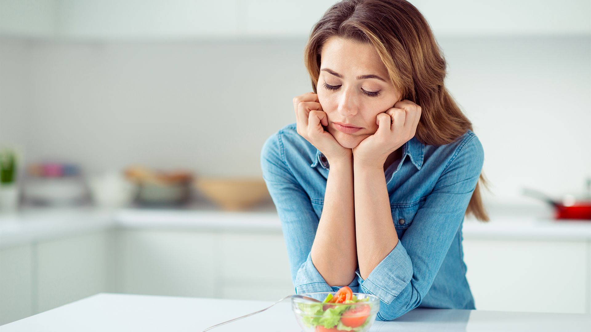 Close-up portrait of her she nice lovely charming attractive sad bored dull disappointed brown-haired lady looking at new green detox vitamin salad in light white interior style kitchen.