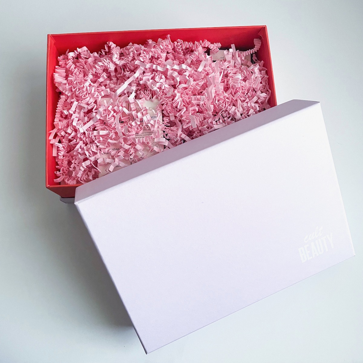 opened pale pink box showing pink crinkle paper