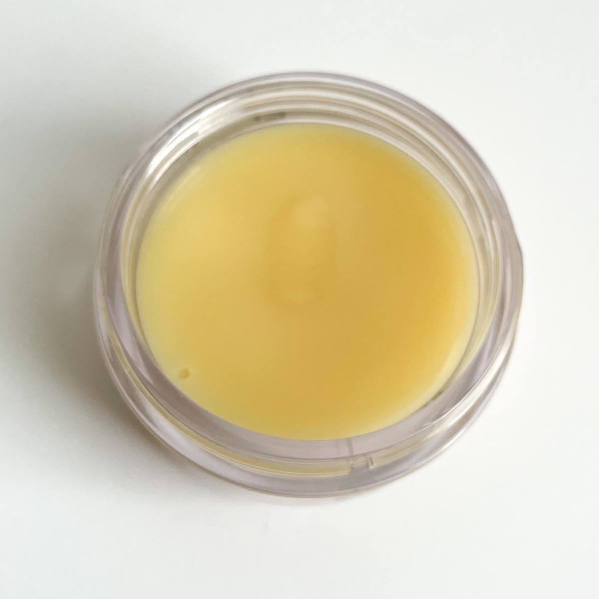 opened jar showing yellow balm texture
