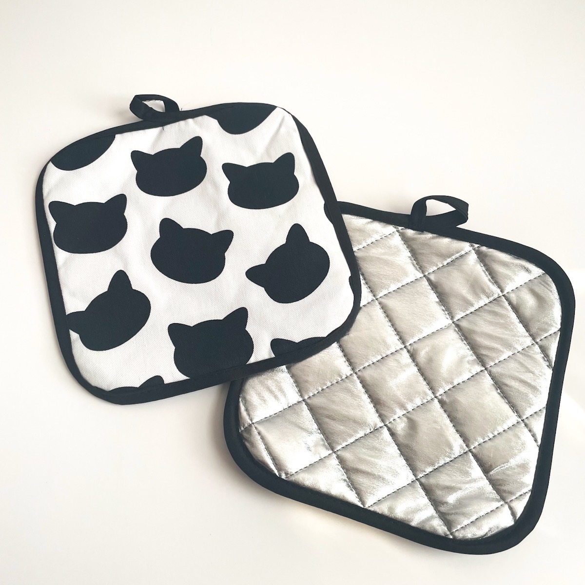 black and white cat potholders with silver side