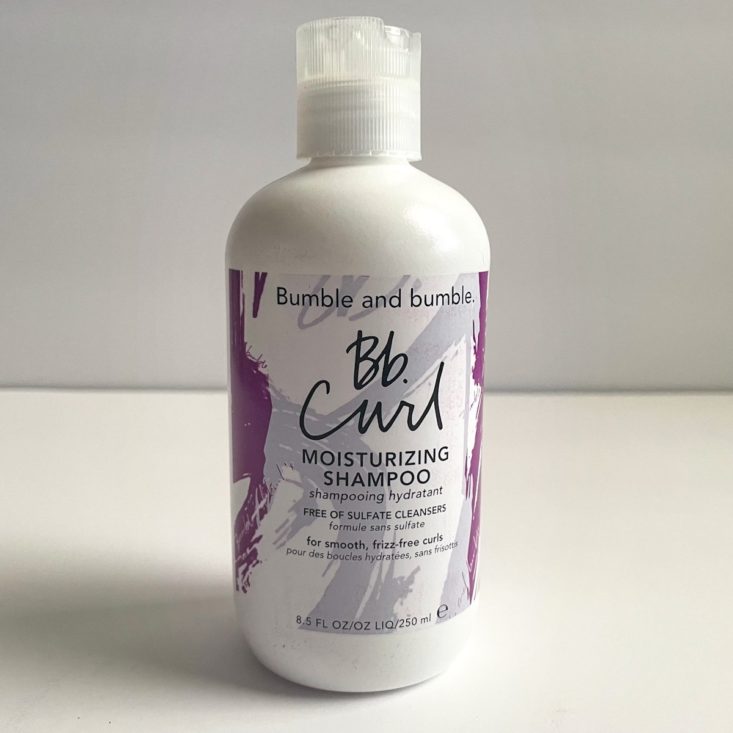 purple and white bottle of shampoo