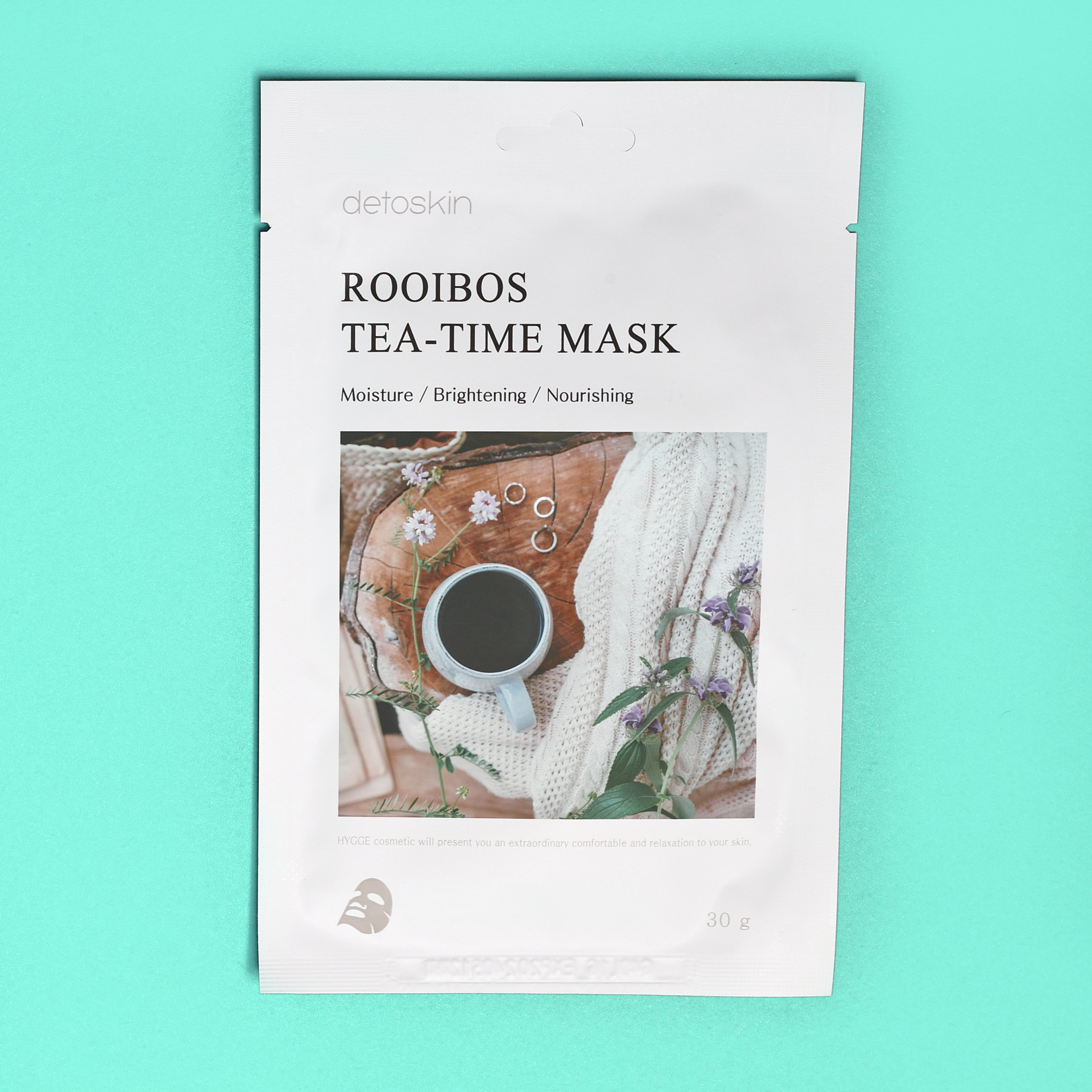 white sheet mask with cup of tea