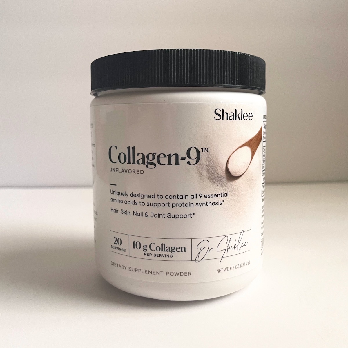 white tub of collagen powder with black lid