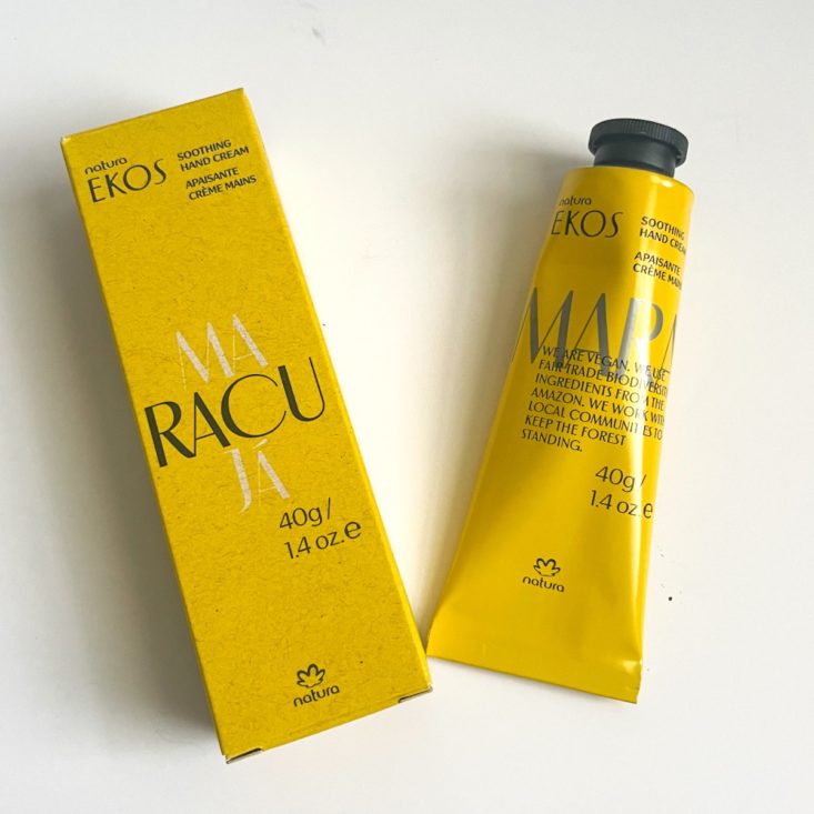 yellow tube of hand cream next to yellow box it came packaged in