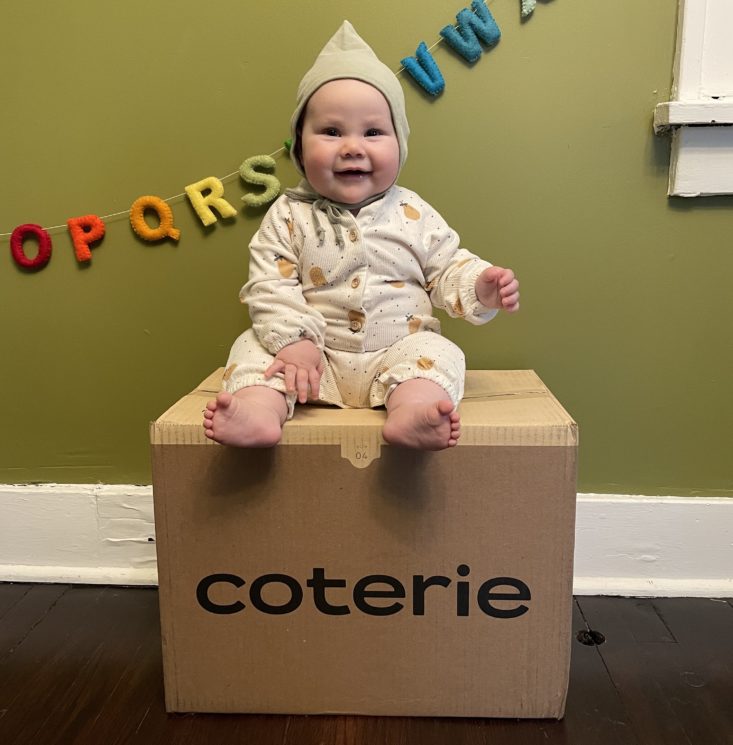 Baby sitting on Coterie box