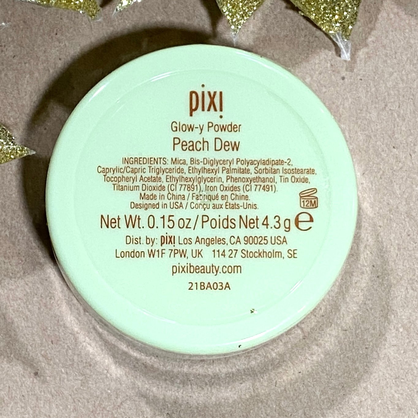 Back of Pixi Beauty Glow-y Powder Peach Dew for the Ipsy Glam Bag December 2021