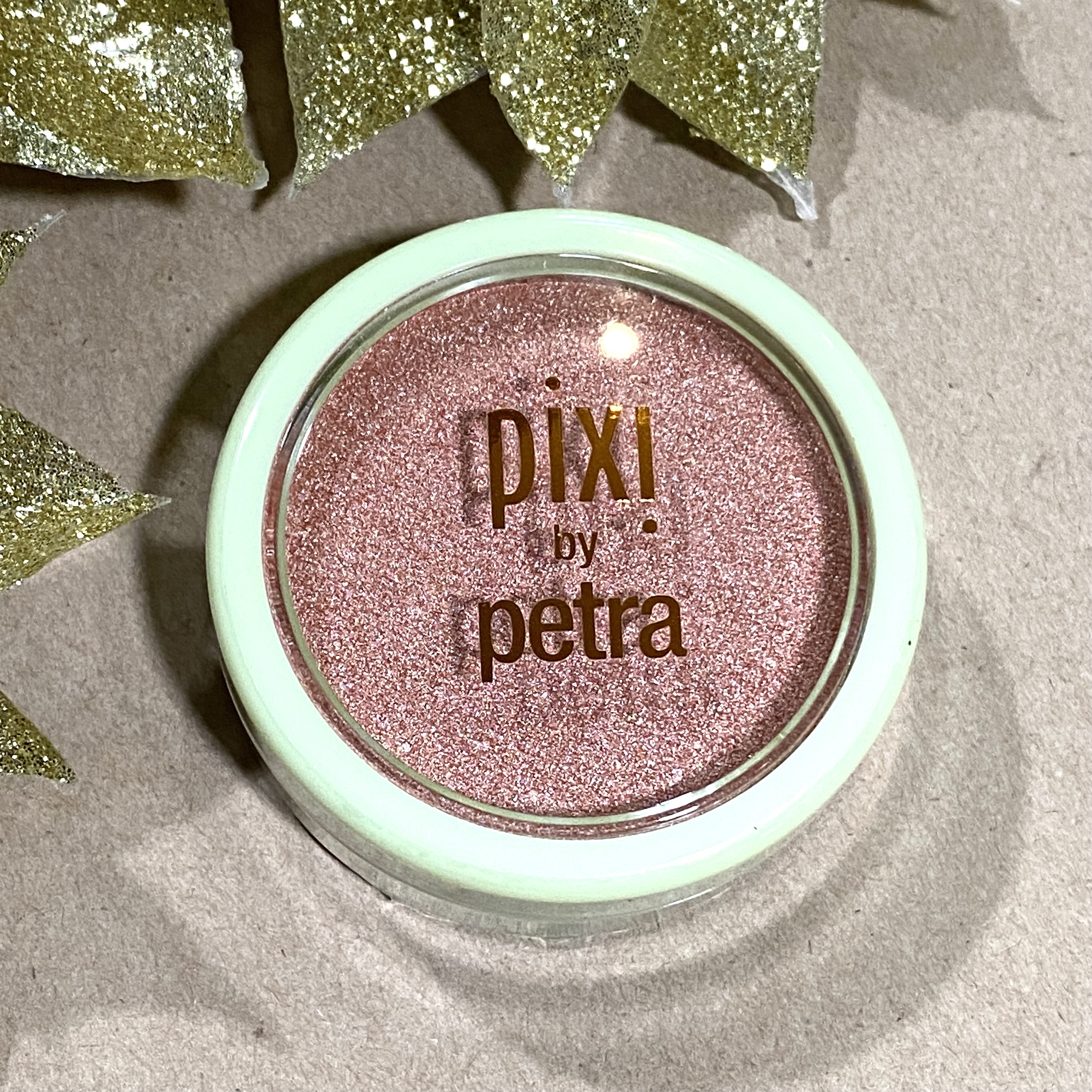 Front of Pixi Beauty Glow-y Powder Peach Dew for the Ipsy Glam Bag December 2021