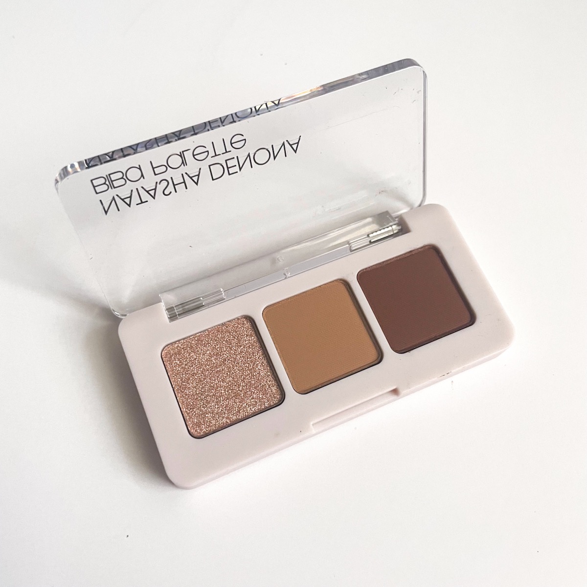 three pan eyeshadow palette, opened, showing neutral brown shades