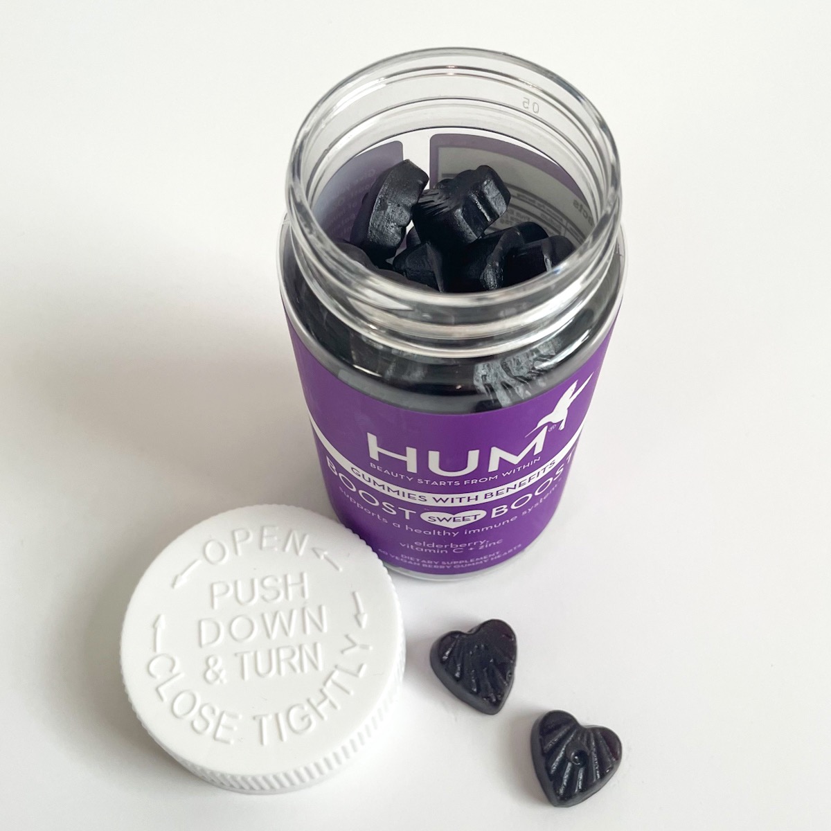 opened purple bottle showing two heart shaped gummies