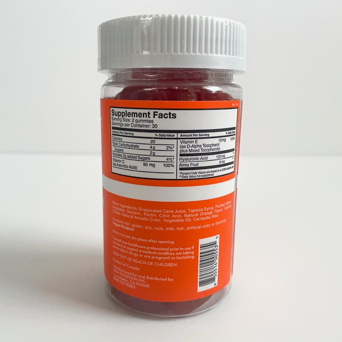 orange bottle with white lid showing nutrition info