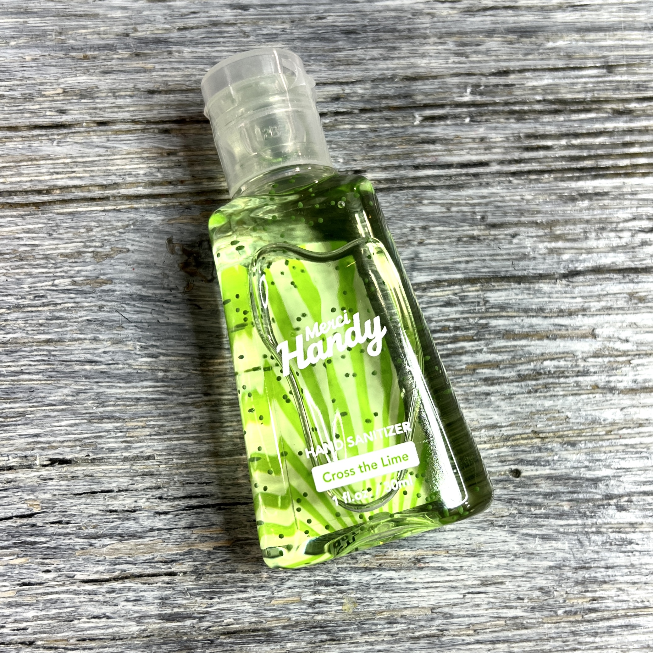 Front of Merci Handy Cross the Lime Hand Sanitizer for Birchbox December 2021